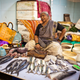 A vendor in one of the city’s oldest fish markets. As a more affluent and increasingly vegetarian population replaces former mill workers, business is suffering.